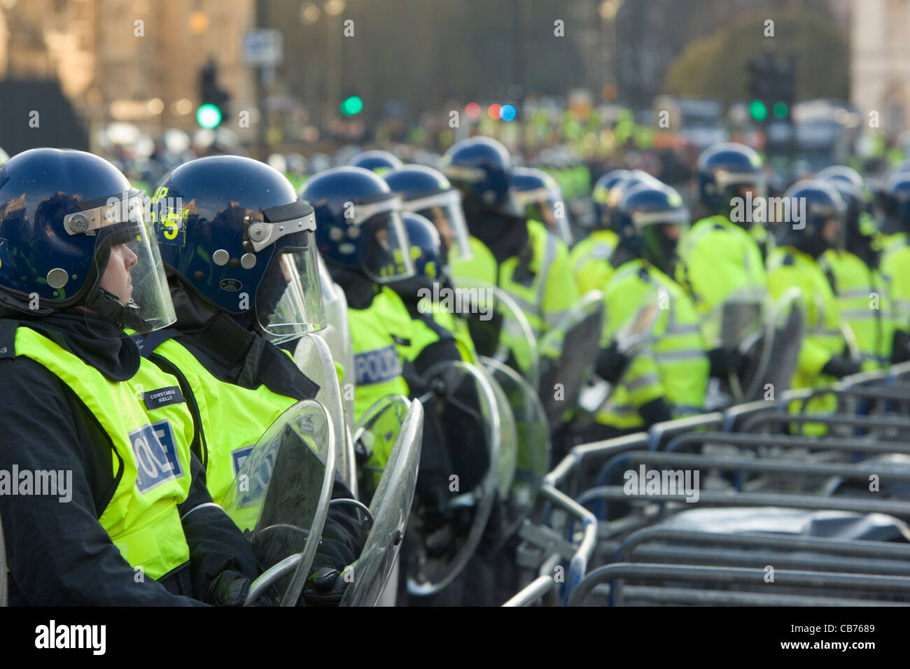 Police line in full riot gear behind barriers protecting Houses of ...