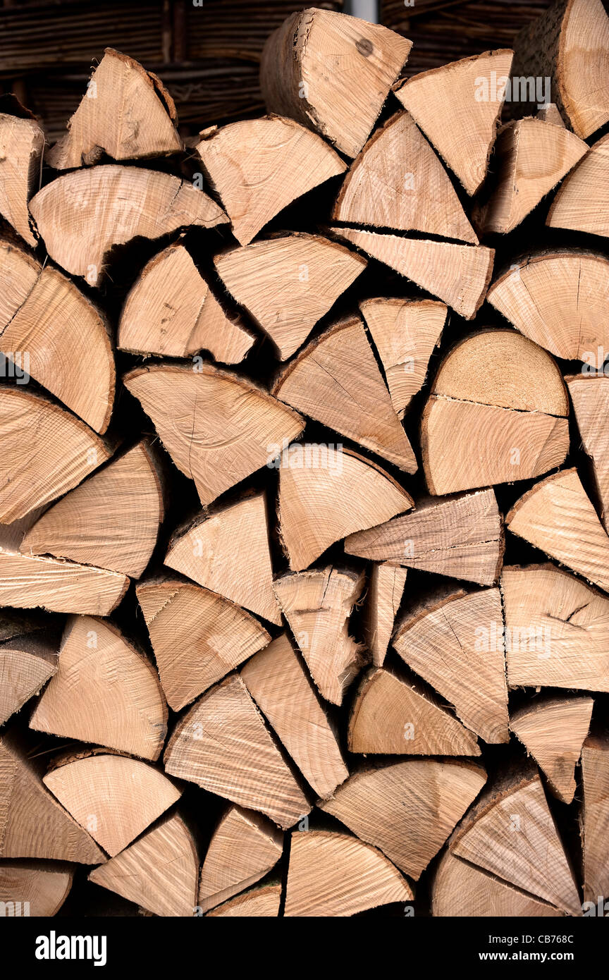 Fire wood stacked up to dry before burning. Stock Photo