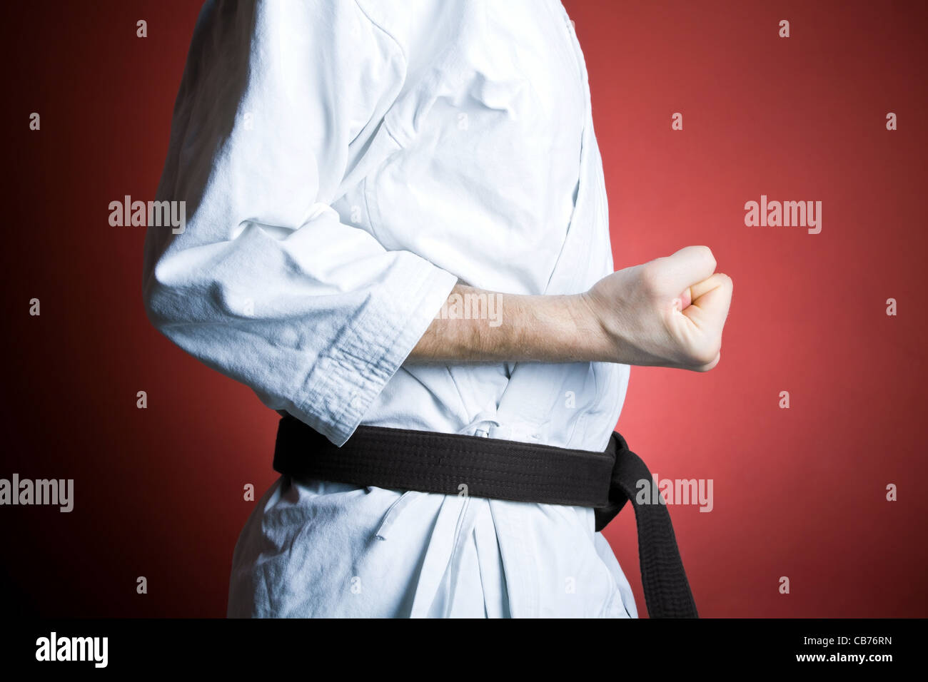 Young man practicing karate over red background Stock Photo - Alamy