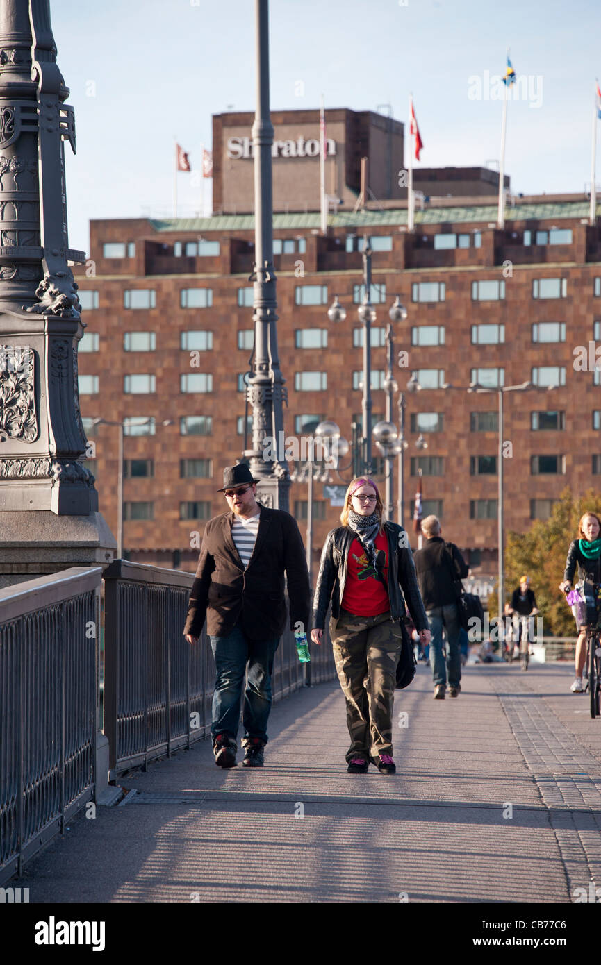 September Saturday walkers and bike-riders on the Vasabron bridge between Norrmalm and Gamla Stan, Old Town in Stockholm Stock Photo