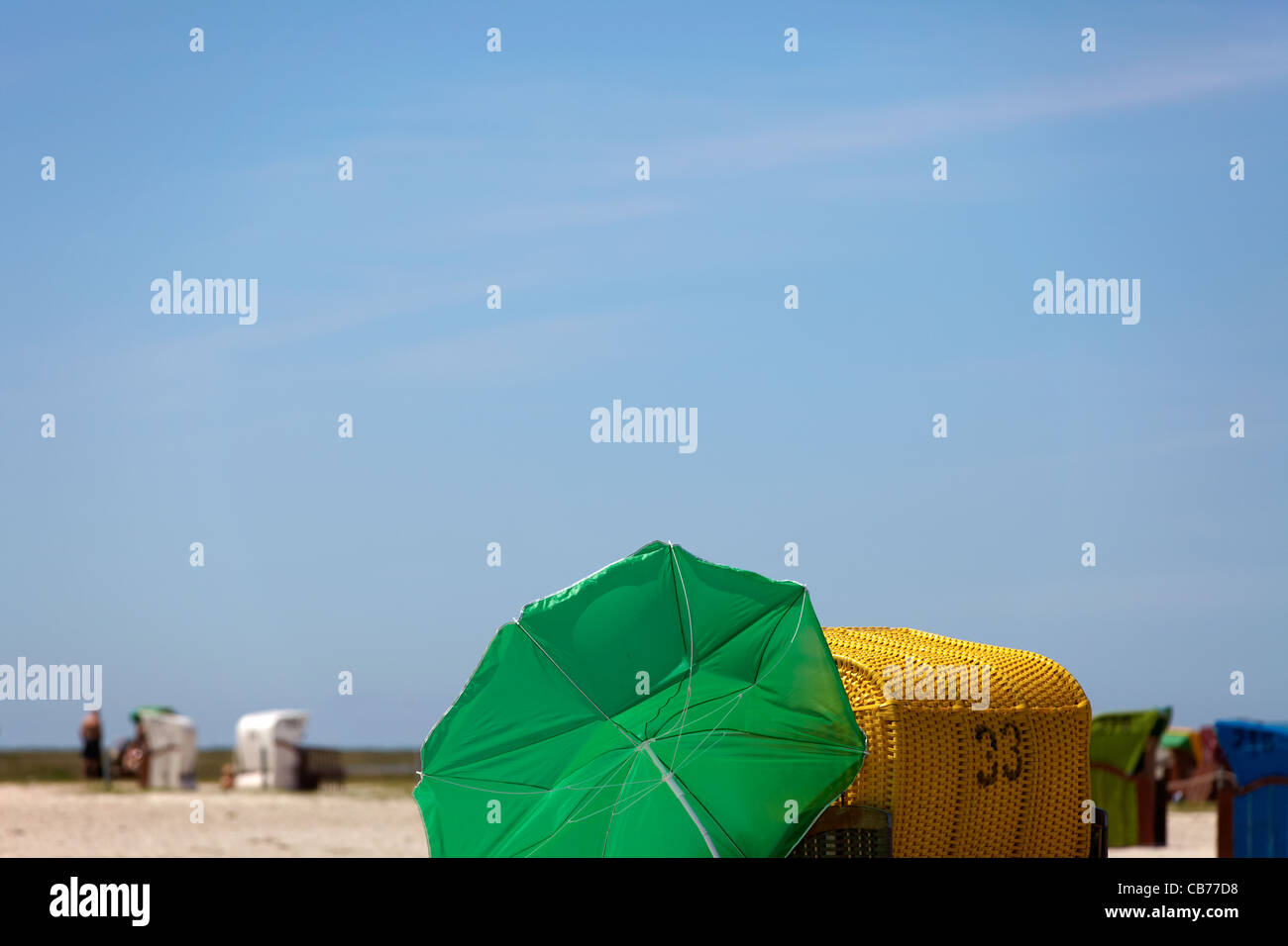 View of a beach umbrella and a wicker beach chair at the German North ...
