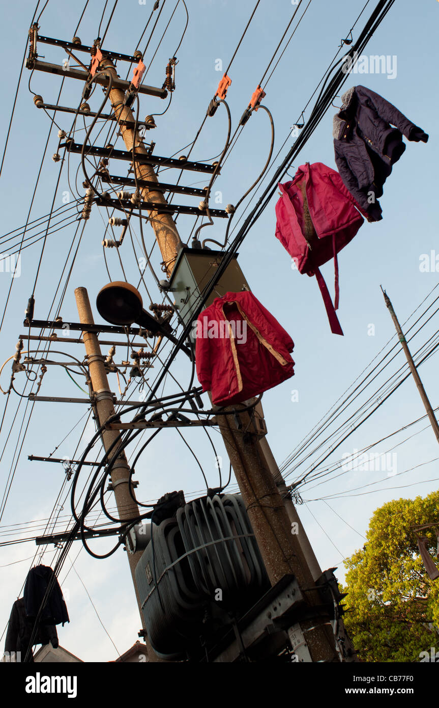 Clothes hang to dry on lines attached to electric poles. Shanghai
