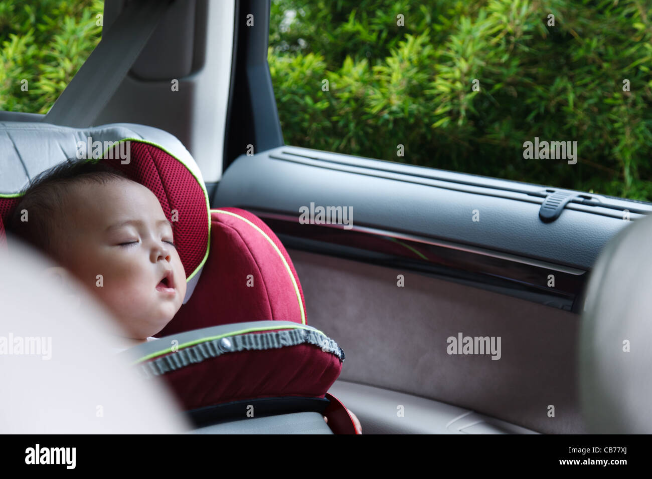 Baby girl asleep in car seat Stock Photo Alamy