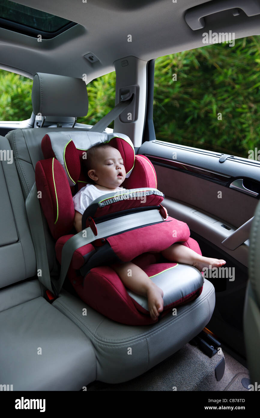Baby girl asleep in car seat Stock Photo Alamy