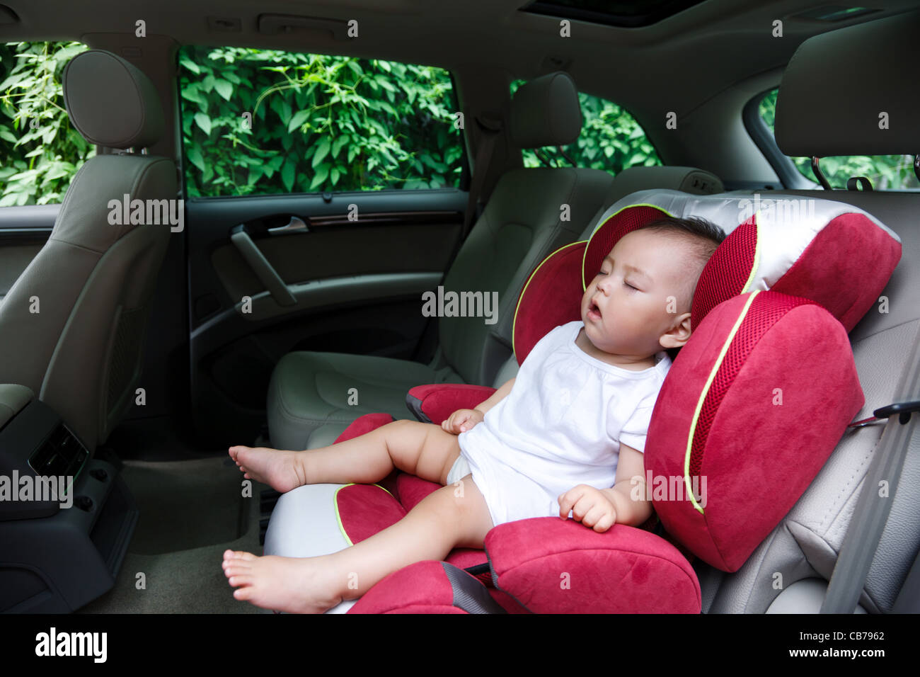 Baby girl asleep in car seat Stock Photo Alamy