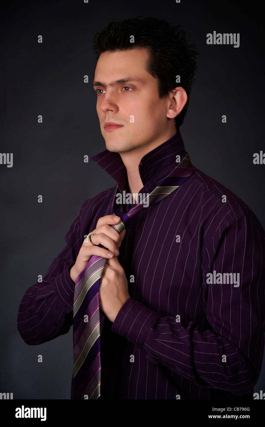 young business man adjusting his tie Stock Photo - Alamy