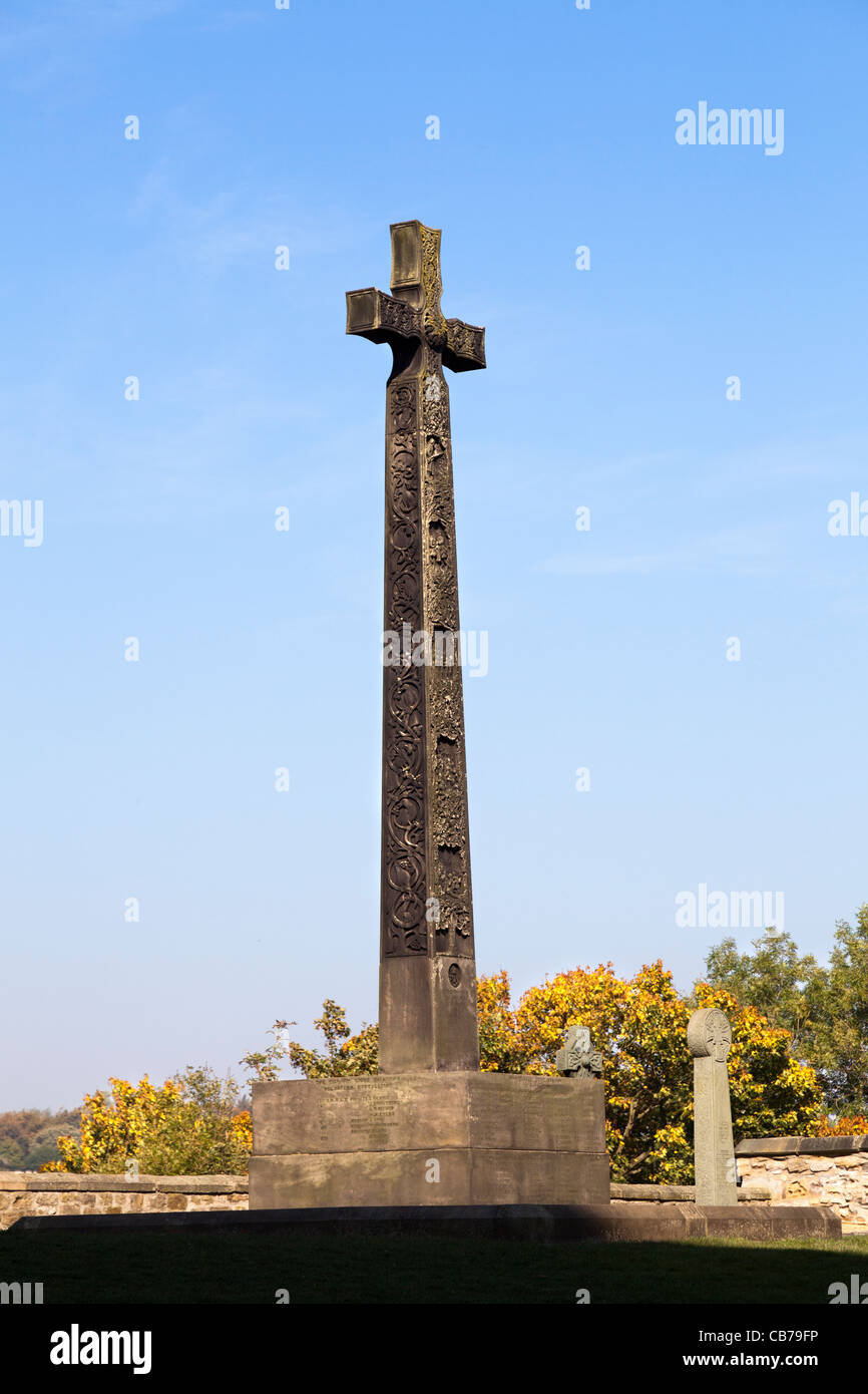 Traditional carved Celtic cross in the graveyard outside Durham Cathedral, Durham, England against a clear, cloudless blue sky Stock Photo