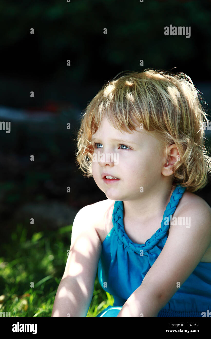 Girl Sitting in Garden Stock Photo - Alamy