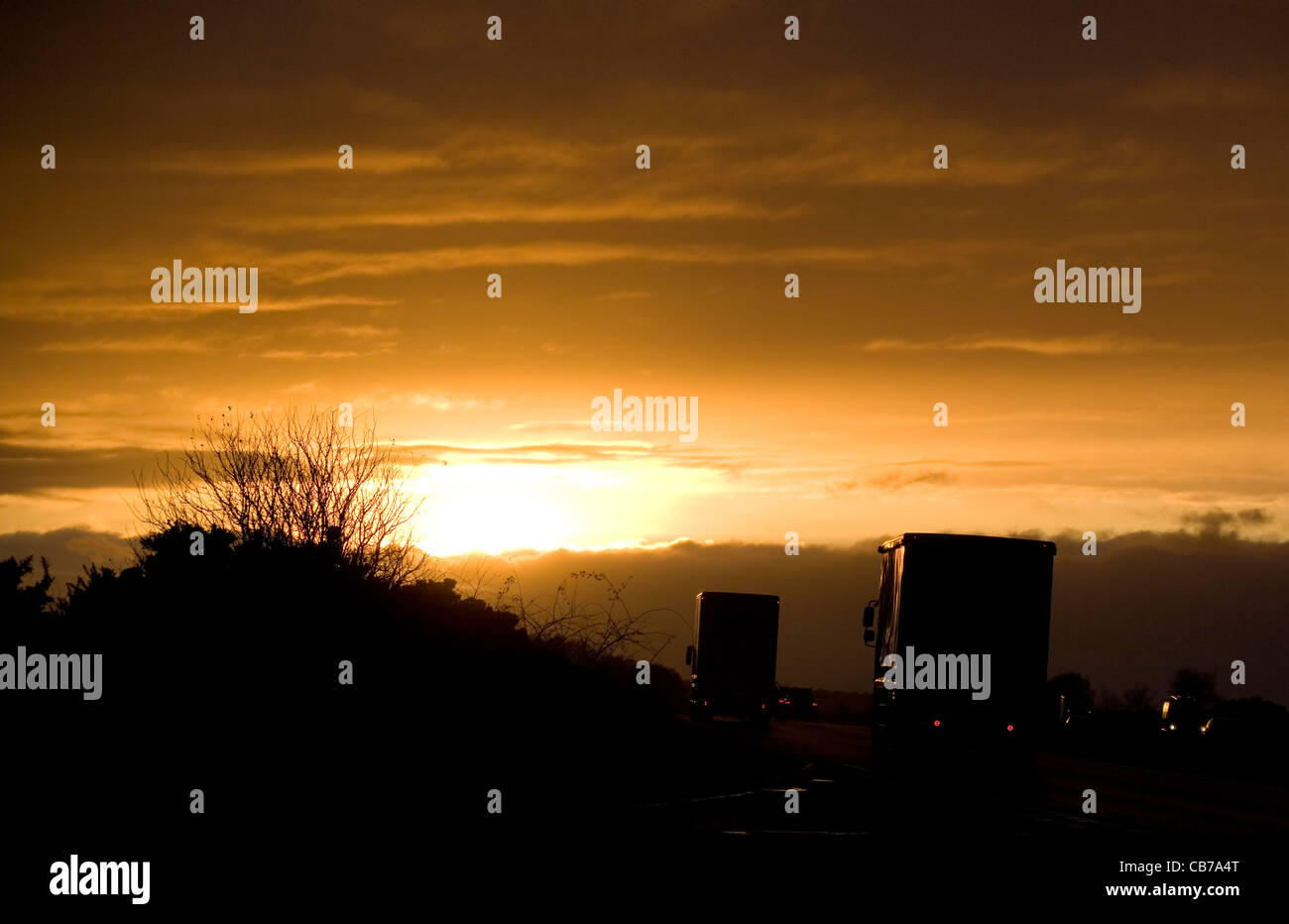 Lorries on a road at sunset in uk Stock Photo