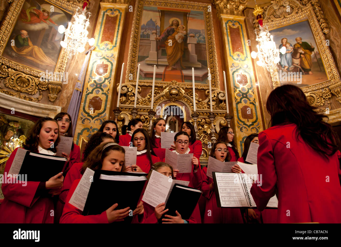 A choir singing during the High Mass at the stroke of midnight on Christmas Eve in the town of Xaghra in Gozo in Malta. Stock Photo