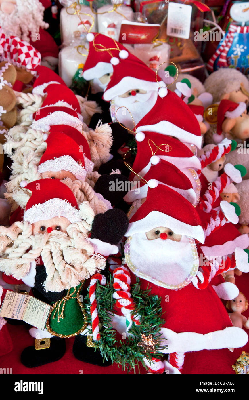 group of jolly hand crafted Santa Claus tree ornaments displayed for sale at Christmas market Mercado Medellin Roma District DF Stock Photo