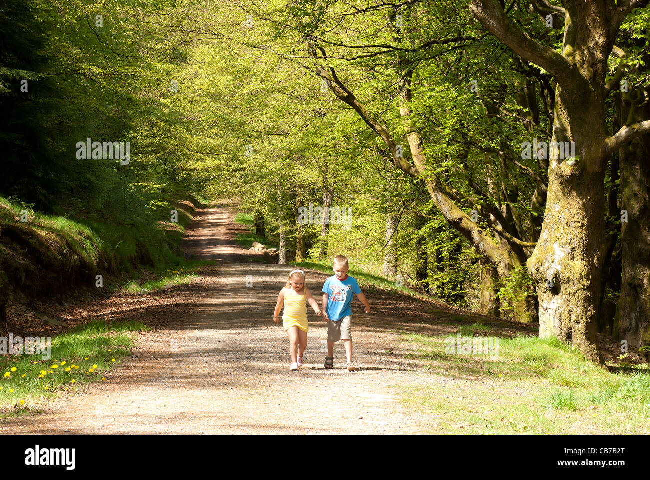 Two children walking along road hi-res stock photography and images - Alamy