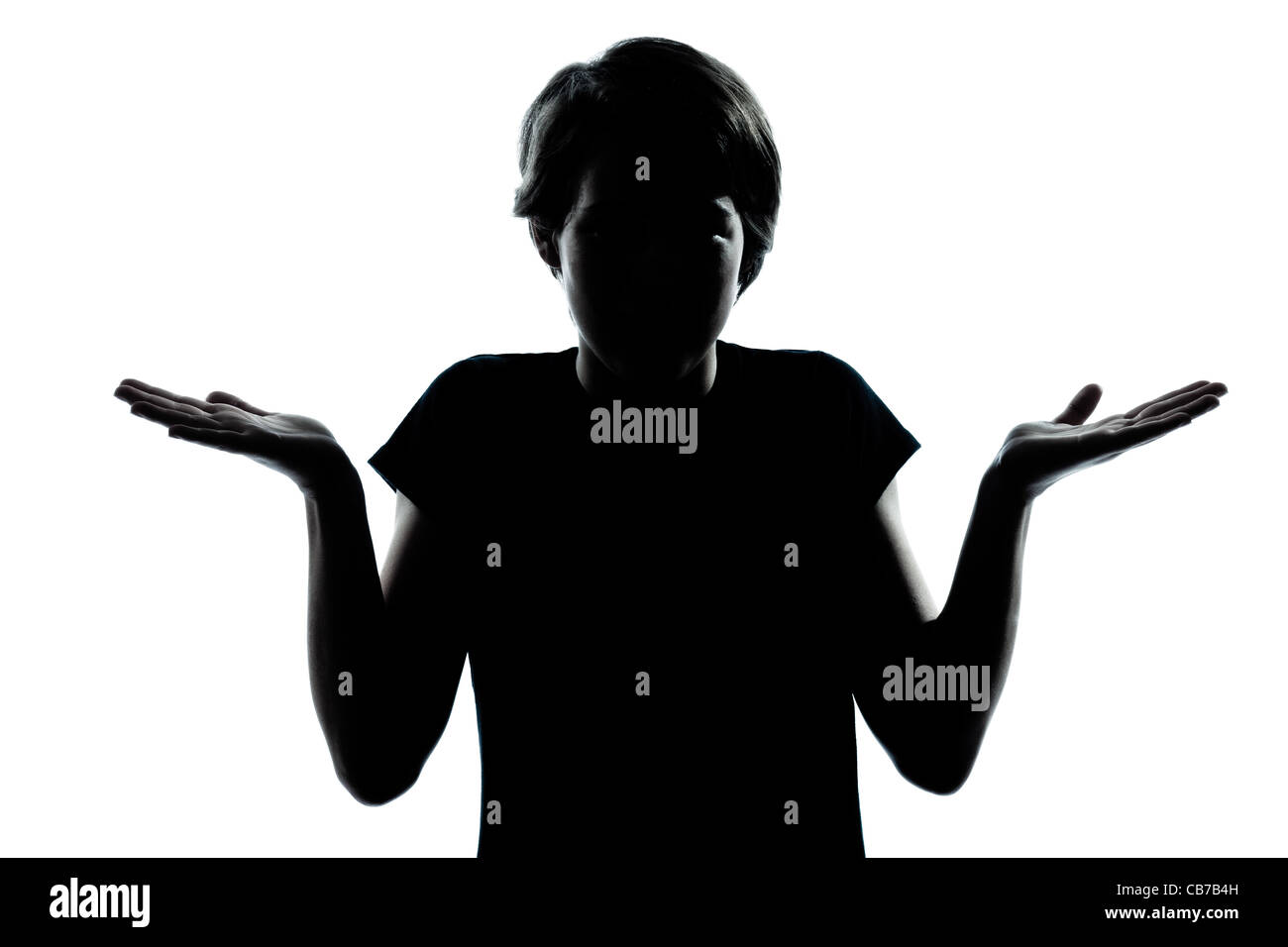 one  young teenager silhouette boy or girl ignorant hesitation shrugging gesture portrait in studio cut out isolated on white background Stock Photo