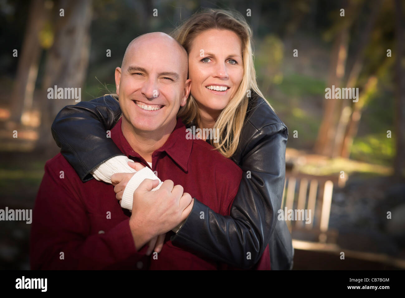 Attractive Hugging Young Couple Portrait in the Park Stock Photo - Alamy
