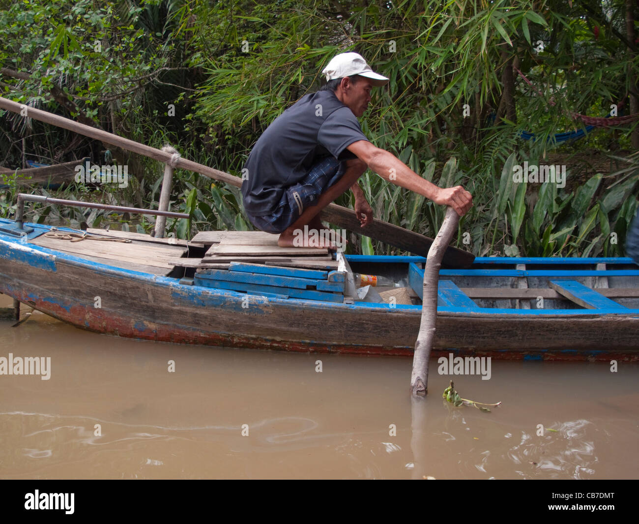 Man rowing a canoe on the River Mekong, Mekong Delta, Vietnam Stock Photo