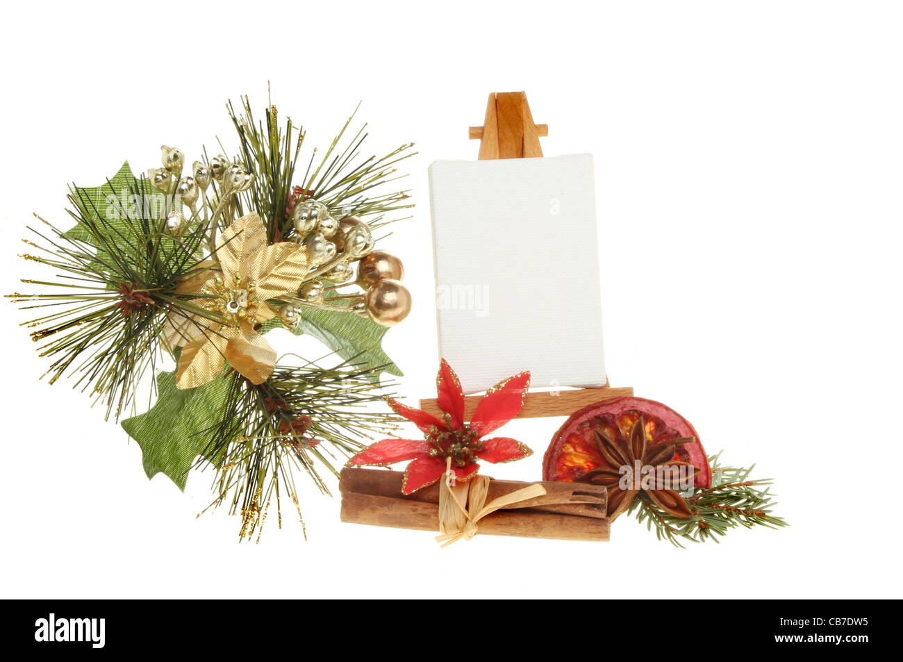 Blank canvas on an easel surrounded by Christmas decorations isolated against white Stock Photo