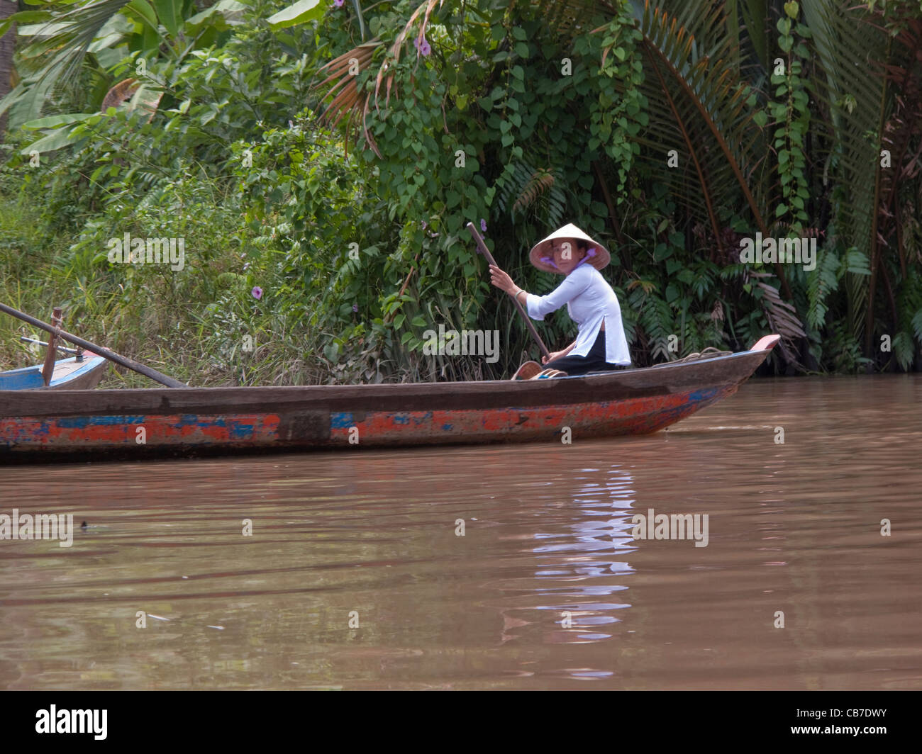 Woman in a rowing boat in the Mekong Delta, Vietnam Stock Photo