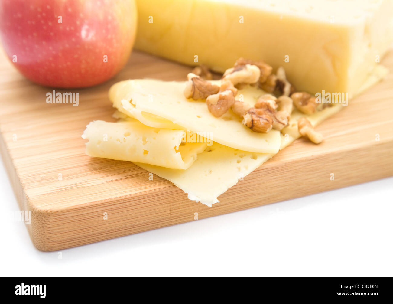 healthy snack slices of cheese, walnut and red apple presented on a