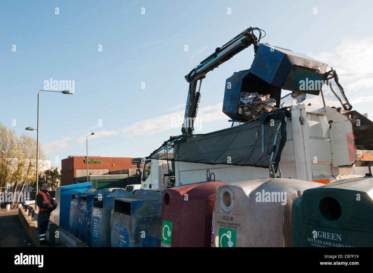 A paperbank being hoisted above a recycling lorry for emptying Stock Photo