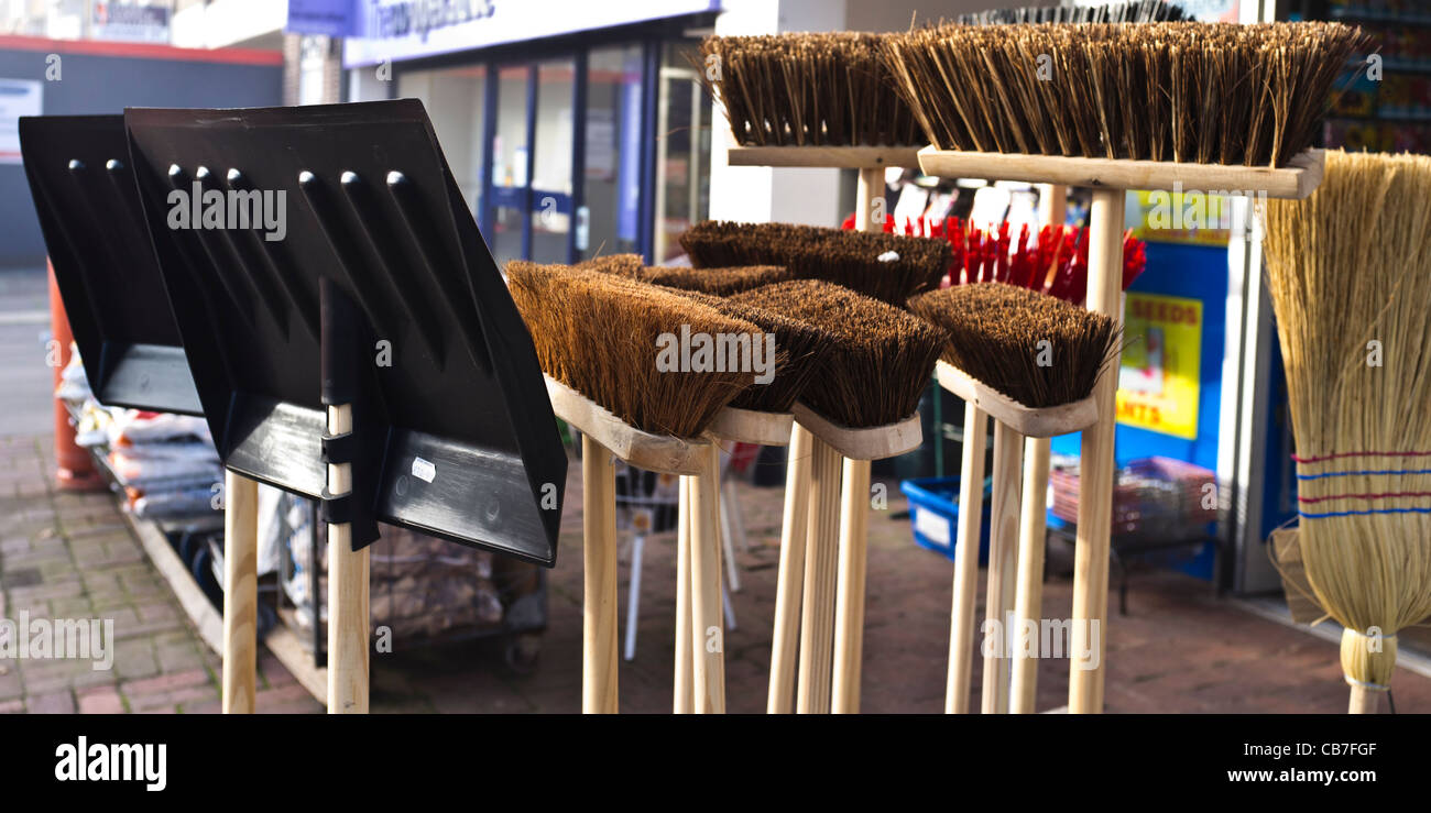 A Snow shovel and brooms for sale outside a shop Stock Photo Alamy