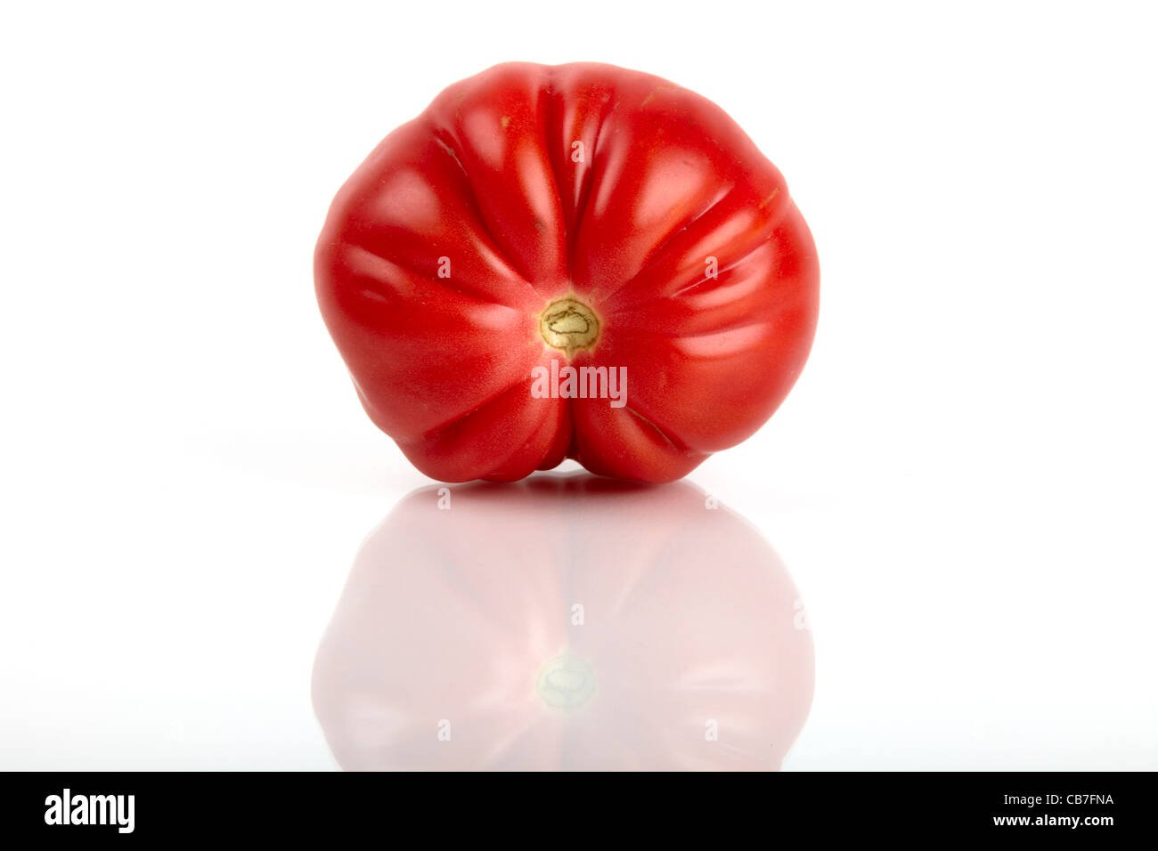 One large red organic tomato isolated on white background Stock Photo ...