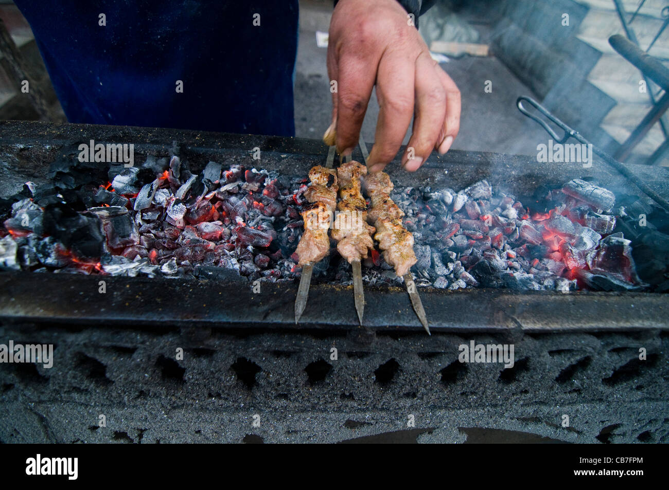 adding spices to  The Shish Kebab. Stock Photo