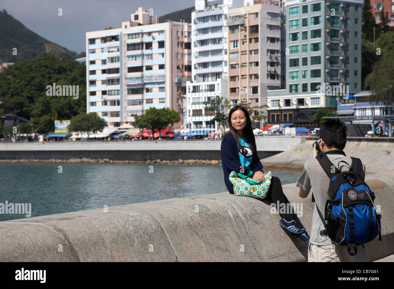 young chinese couple taking photos on stanley waterfront hong kong ...