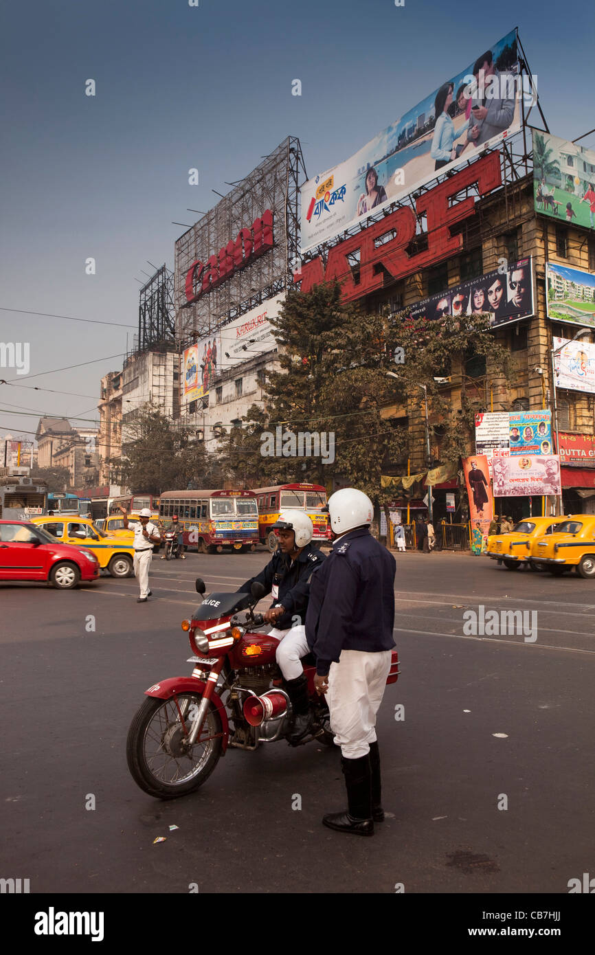 India, West Bengal, Kolkata, traffic policemen below advertising hoardings at Bentinck Street Junction Stock Photo