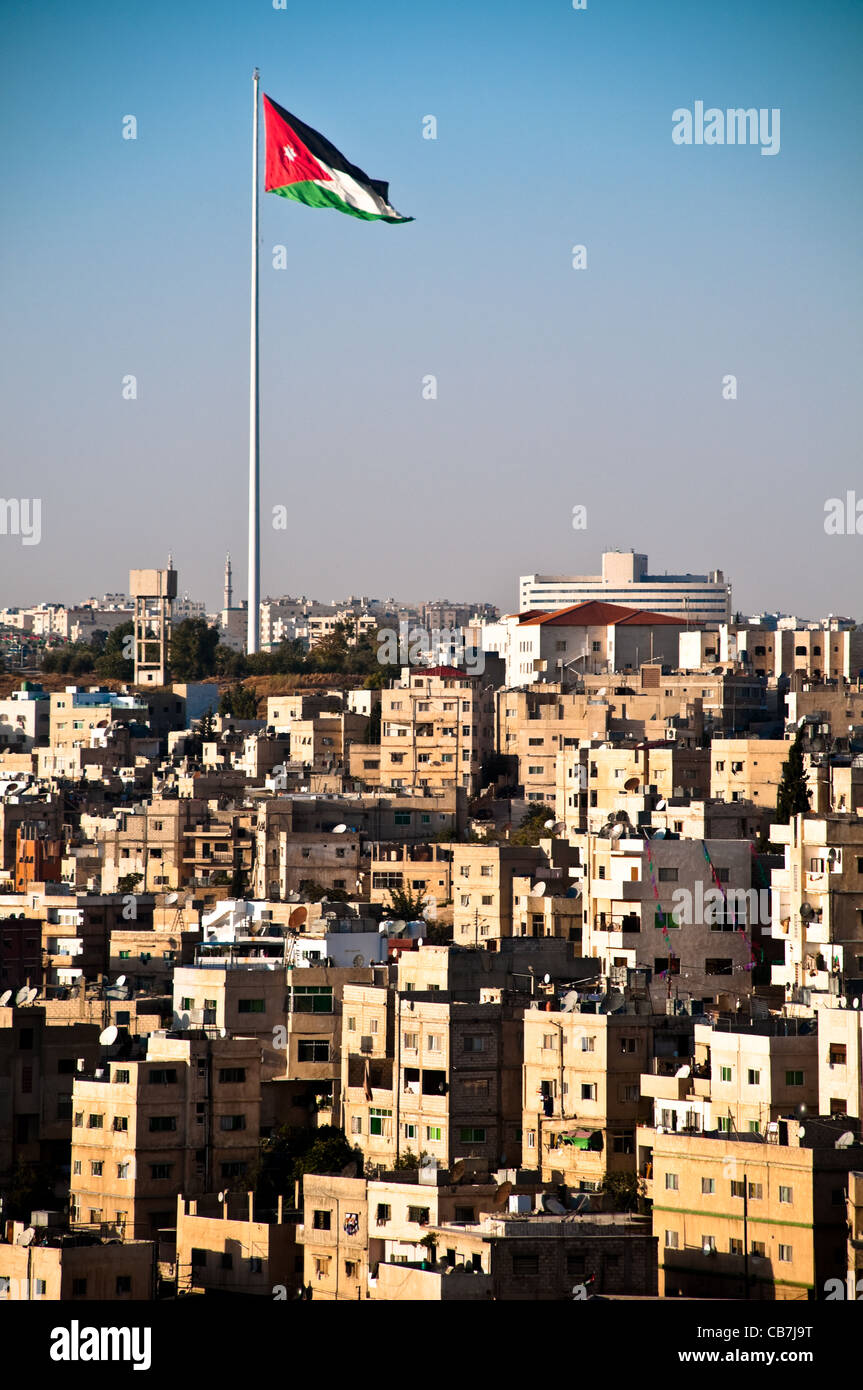 view of city of Amman with giant jordanian flag and blue sky in background  Stock Photo - Alamy