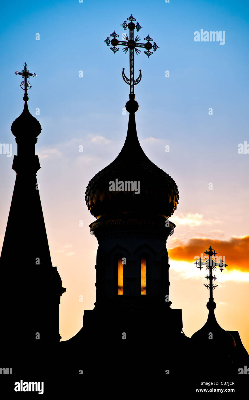 Beautiful silhouette of russian church domes against cloudy sunset sky Stock Photo