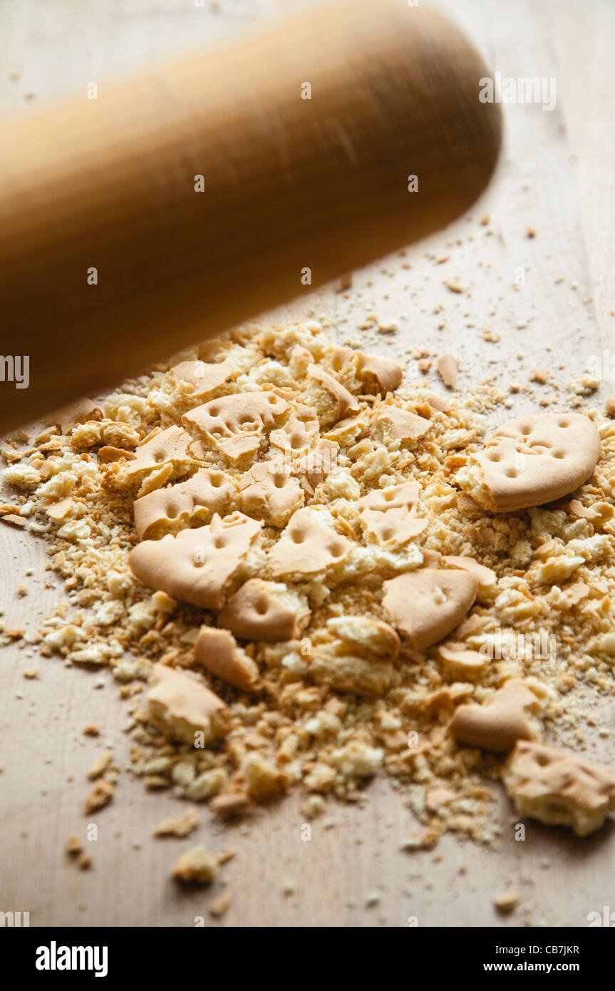 A moving rolling pin showing the smashing up of a biscuit into tiny