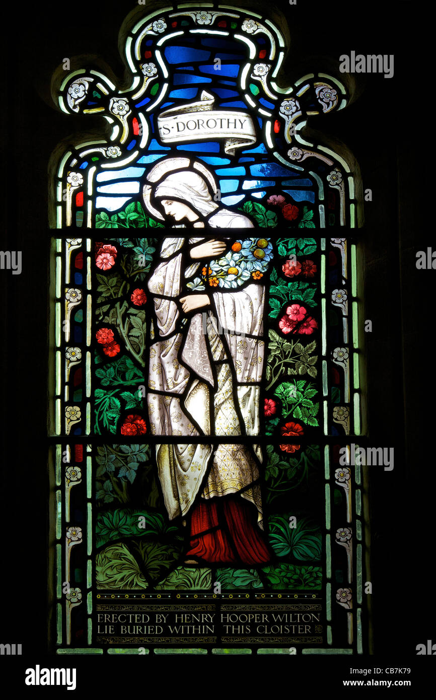Stained glass window of St Dorothy, by  Stephen Coyne, Morris & Co, 1924, cloisters, Gloucester Cathedral, Gloucestershire, UK Stock Photo