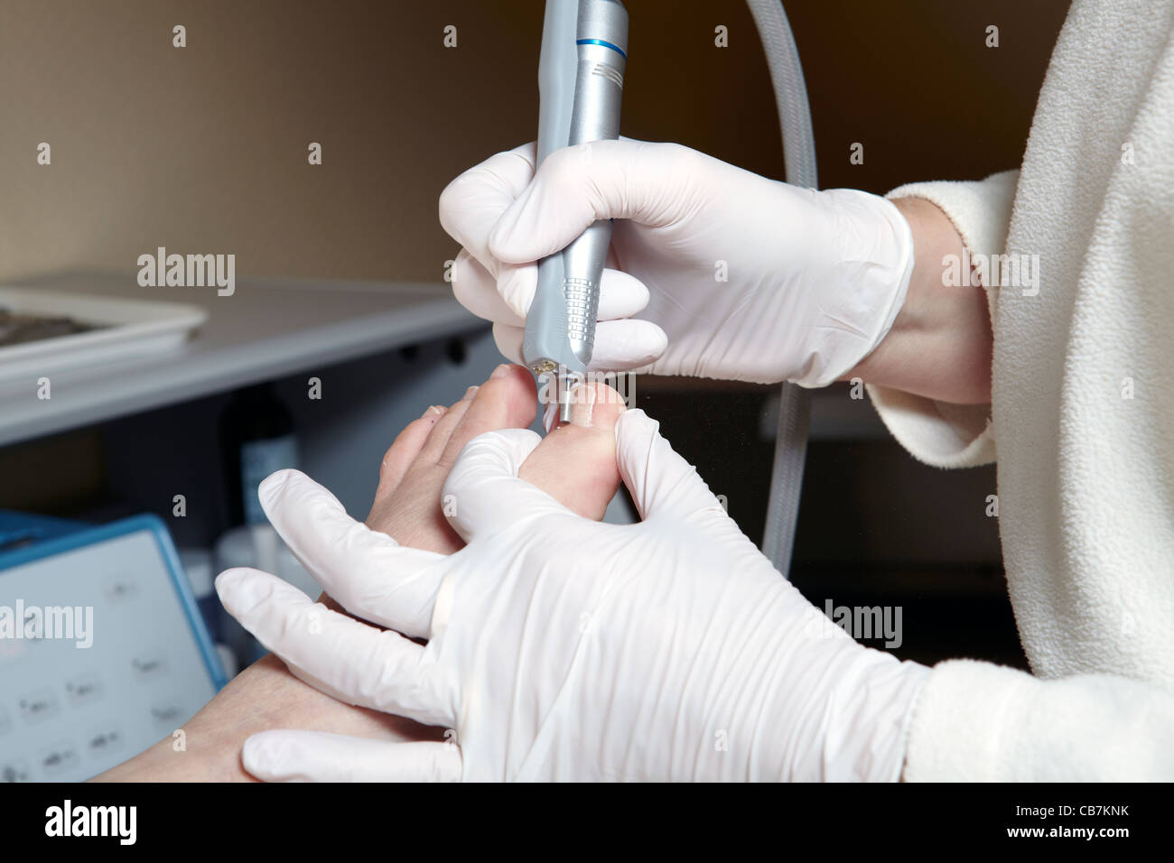 A podiatrist edit the toenails with a grinding machine Stock Photo Alamy