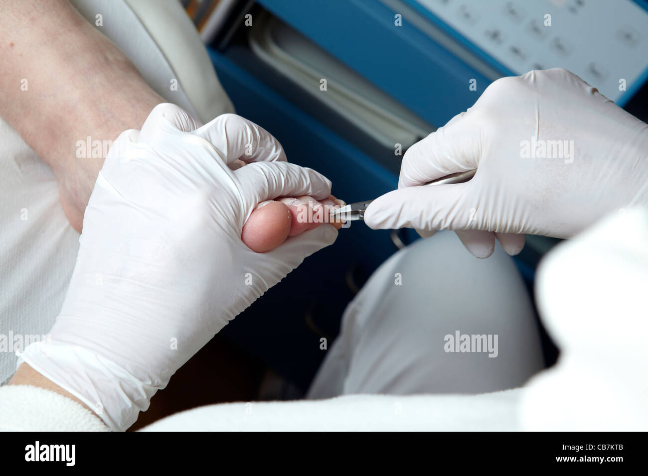 A Podiatrist cut the toenails of a woman Stock Photo