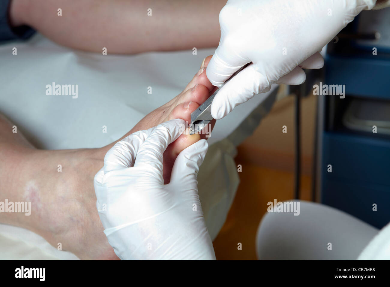 A Podiatrist cut the toenails of a woman Stock Photo