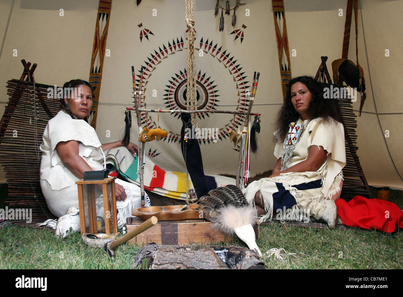 Two Native American Indian women sitting inside a tipi Stock Photo