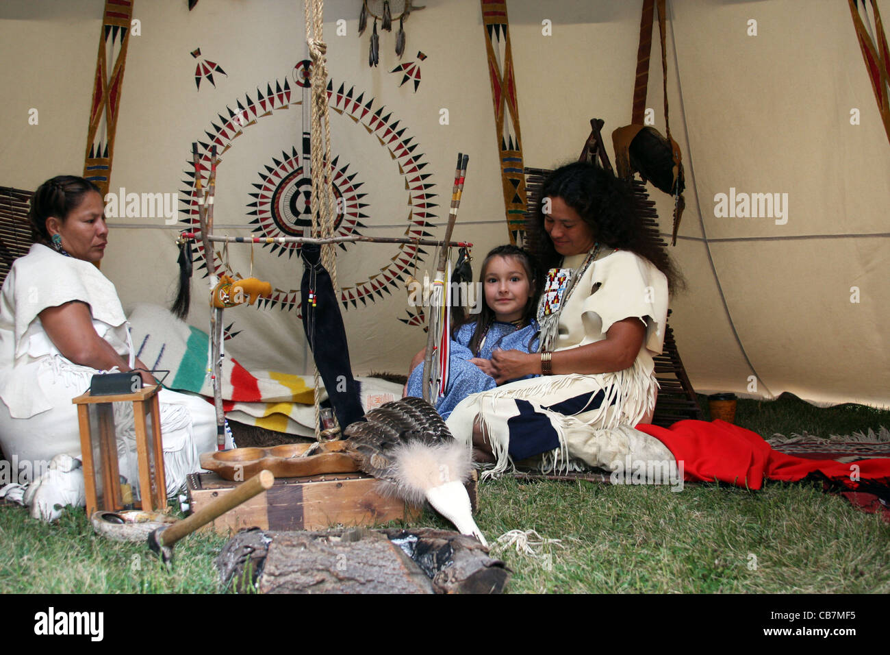 Two Native American Indian women and a child inside a tipi Stock Photo