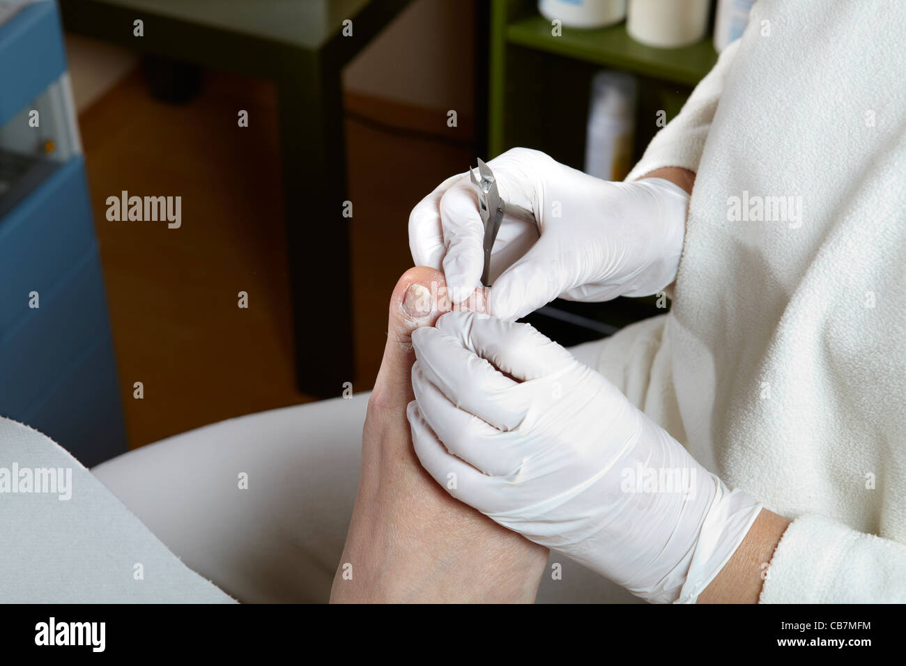 A Podiatrist cut the toenails of a woman Stock Photo
