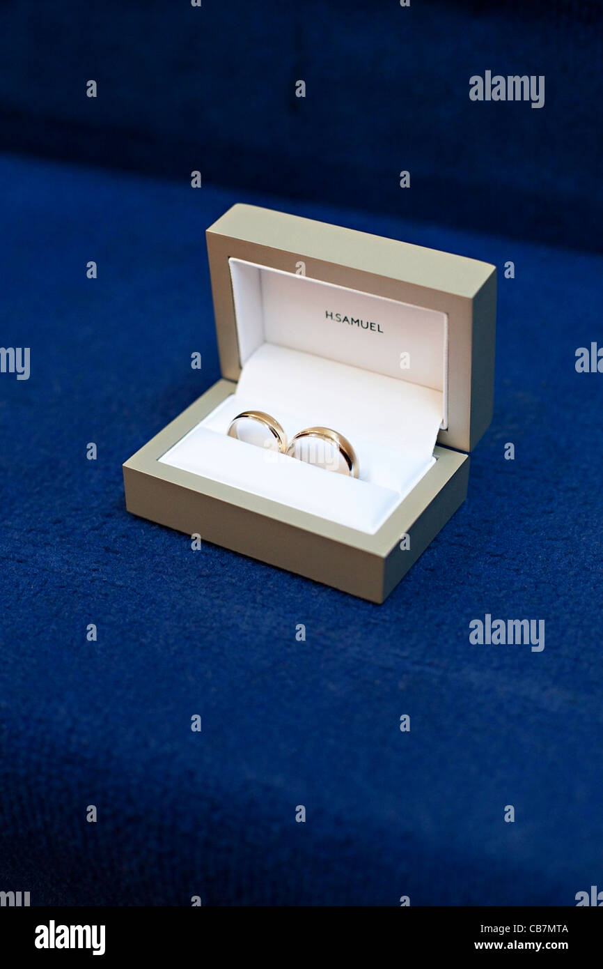 Wedding rings in boxes from H.Samuel on blue carpet Stock Photo - Alamy