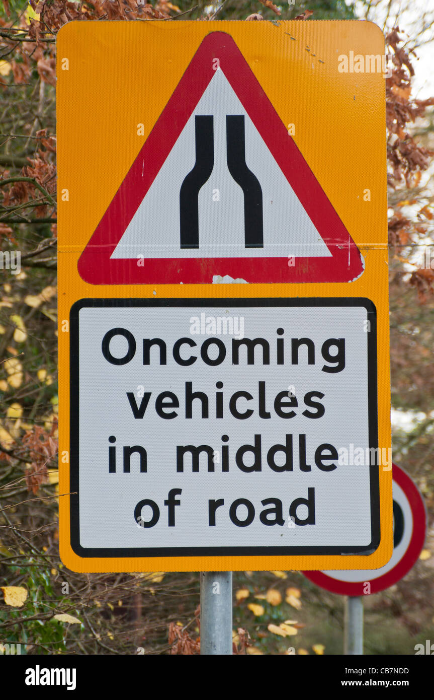 Warning road sign 'Oncoming vehicles in middle of road' Stock Photo