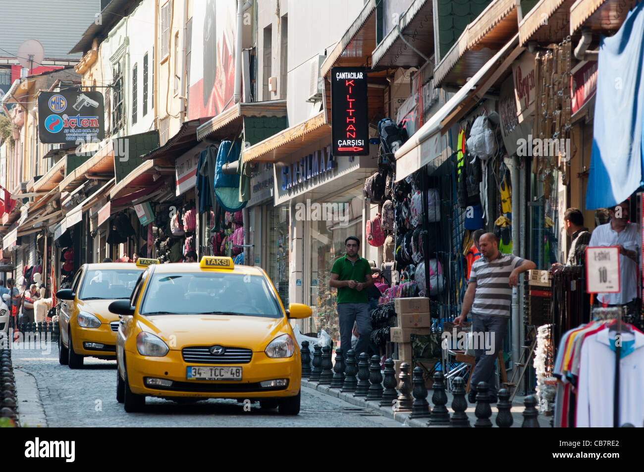 Yellow taxi cabs in shopping street near Grand Bazaar, Istanbul, Turkey. Stock Photo