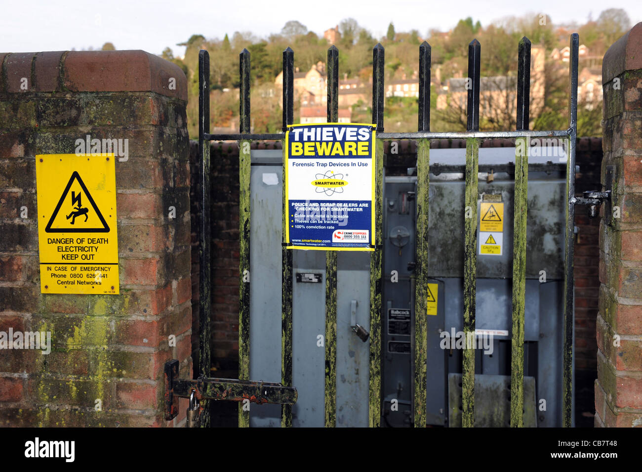 Danger and Smartwater warnings to signs to metal thieves at electricity sub station uk Stock Photo