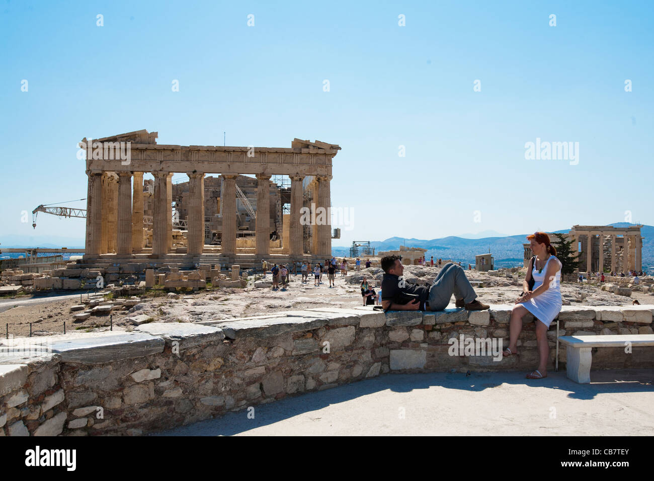 Travel and architecture shots from Greece - A tourist couple relax by the Parthenon in Athens Akropolis Stock Photo