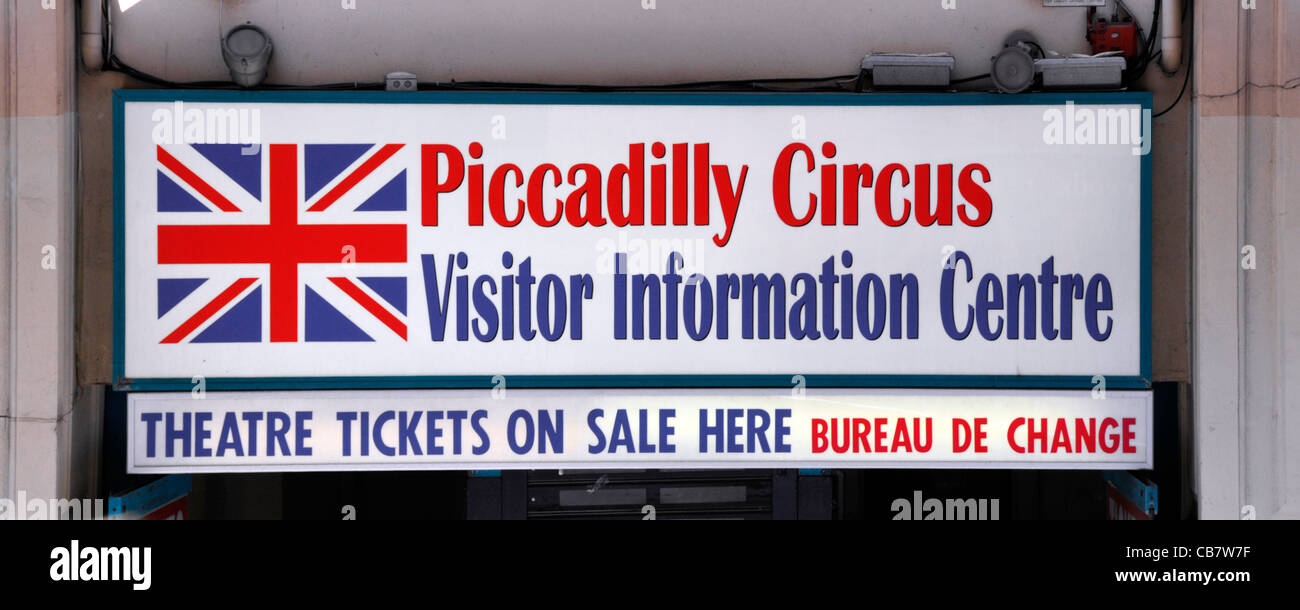 Sign for Piccadilly Circus Visitor Information Centre & Bureau de Change above shop front in a busy popular tourist area of London West End England UK Stock Photo