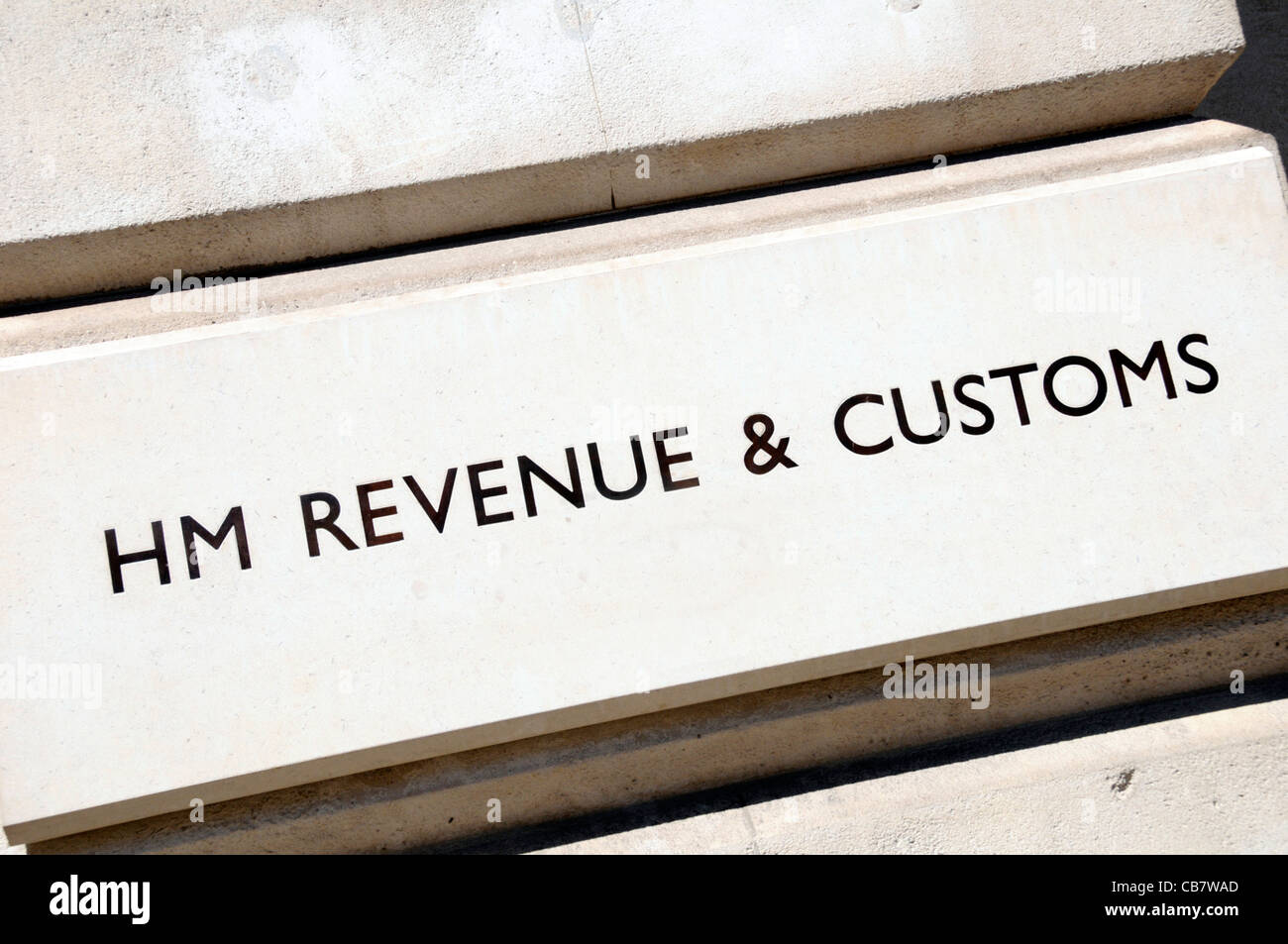 Sign outside uk government tax collection office building for HM Revenue and Customs also referred to as HM Revenue in Whitehall London England UK Stock Photo