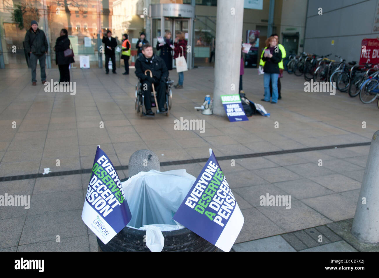 One day strike against pension cuts by public sector workers. Picket at Hackney Central library. Rubbish bin with Unison flags Stock Photo
