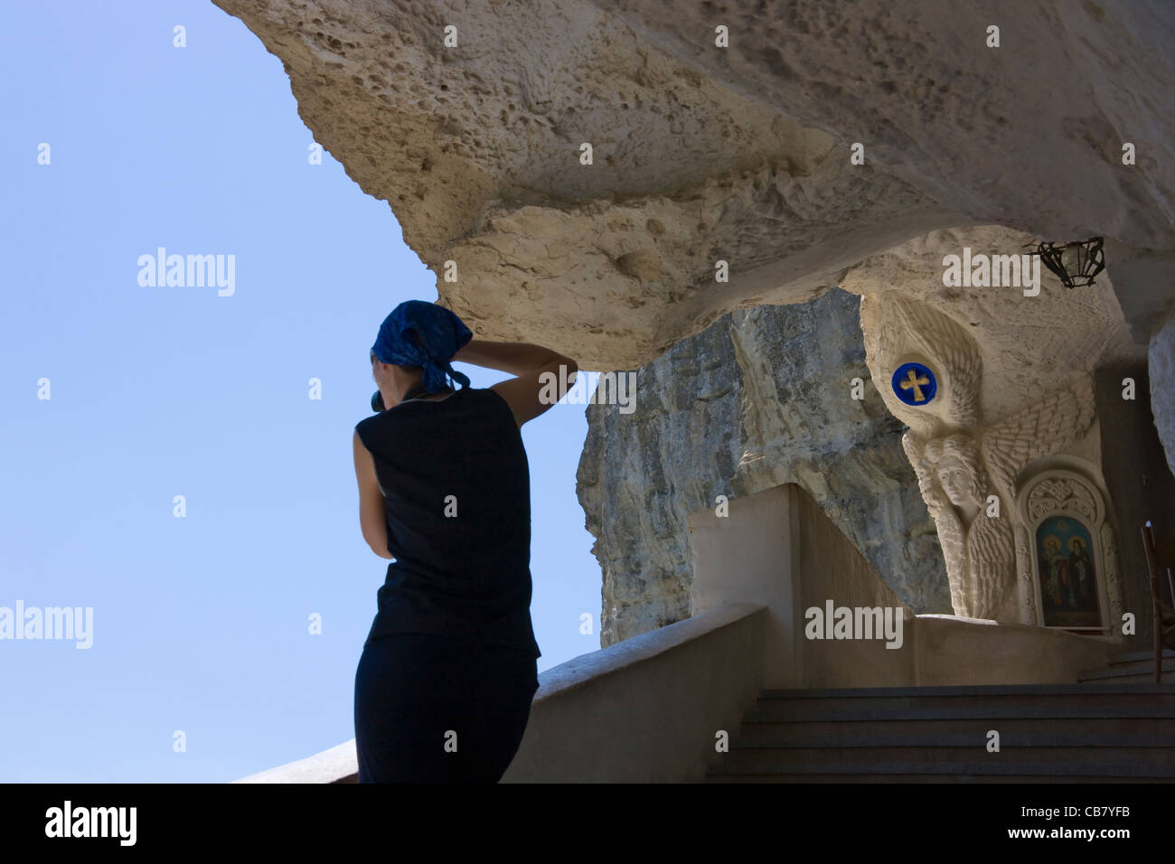 Tourist photographing Uspensky Cave Monastery, Crimea, Ukraine Stock Photo