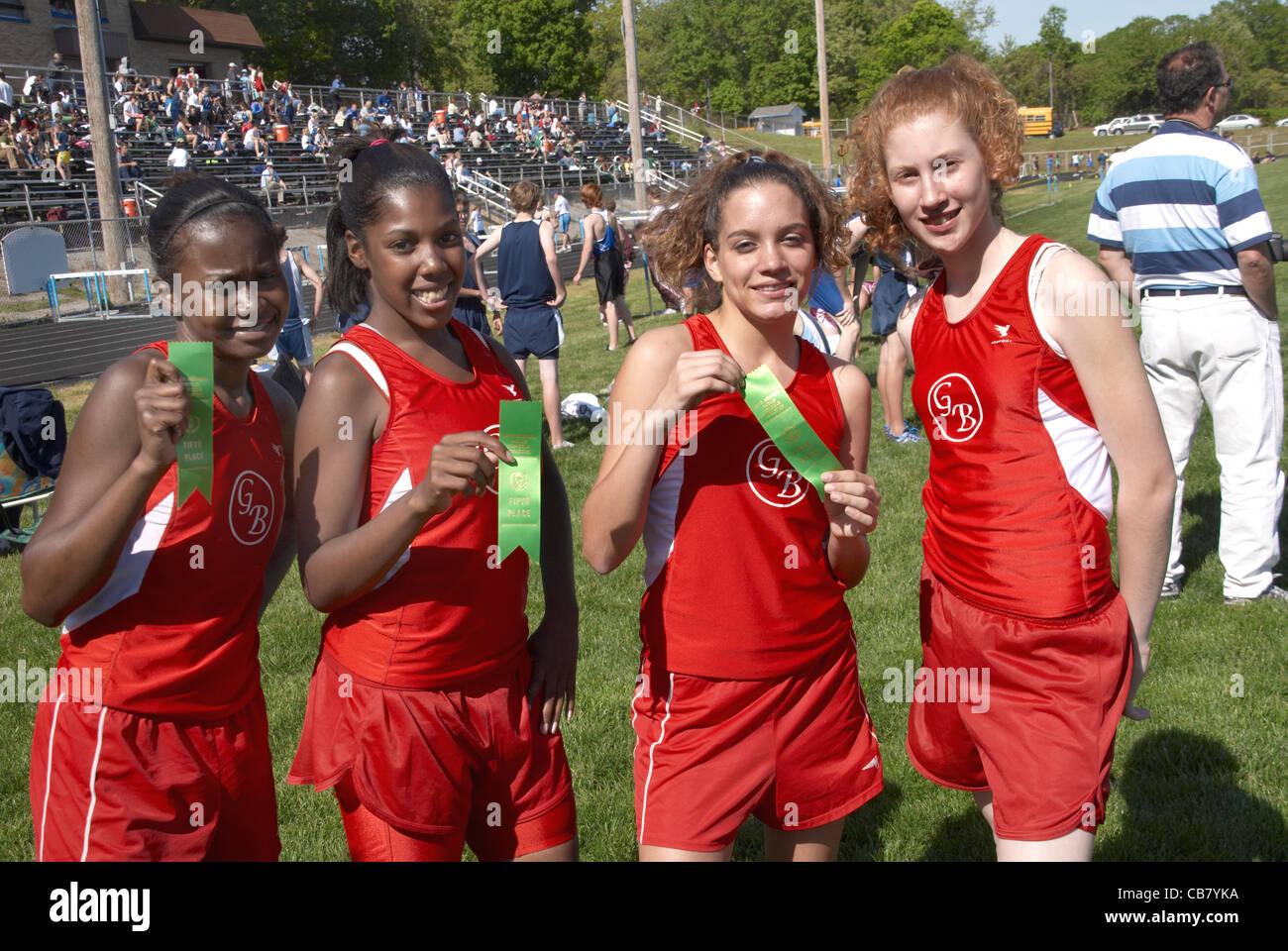 girls show the fifth place ribbons they won in a track meet in