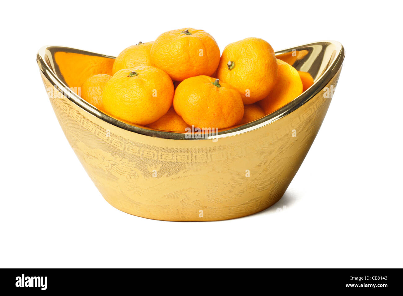Mandarin oranges in gold ingot container on white background Stock Photo