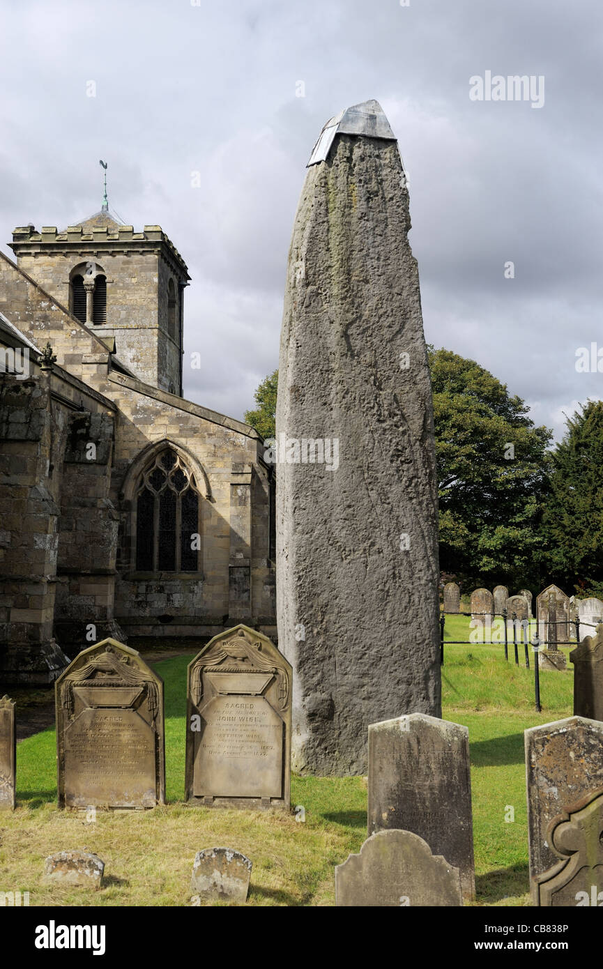 Rudston monolith, late Neolithic 26 ft. standing stone beside Rudtson Parish Church of All Saints, East Yorkshire, England, UK Stock Photo